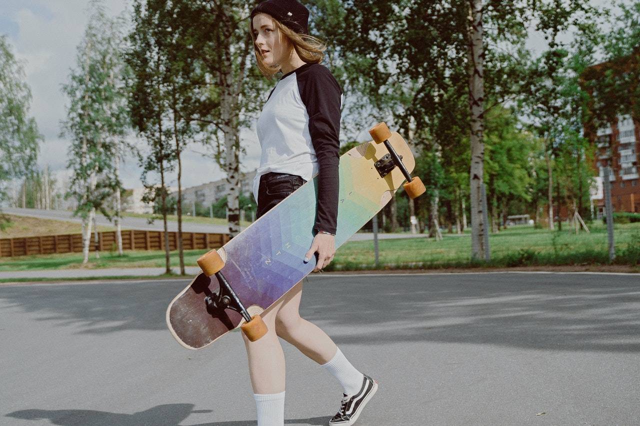 a girl carrying a skateboard - Darren Yaw Cambodia